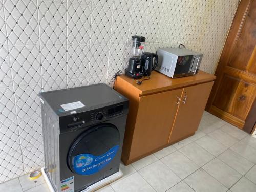 a washing machine sitting on a counter next to a blender at BonaAirport apartments in Douala