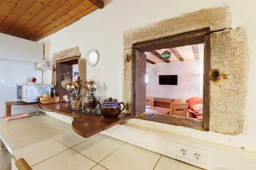 a kitchen with a counter and a table in a room at Haugstetter Schwarzwaldhaus in Neubulach