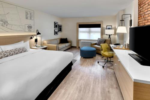 a hotel room with a bed and a desk at The Insignia Hotel, Sarnia, a Tribute Portfolio Hotel in Sarnia