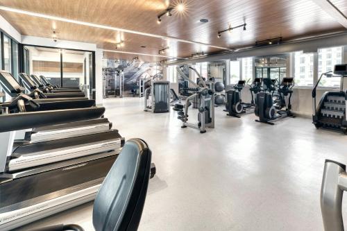 a gym with treadmills and elliptical machines at The Insignia Hotel, Sarnia, a Tribute Portfolio Hotel in Sarnia