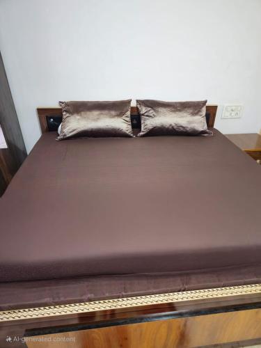a bed with a pillow on top of it at Agrima palace in Rewa