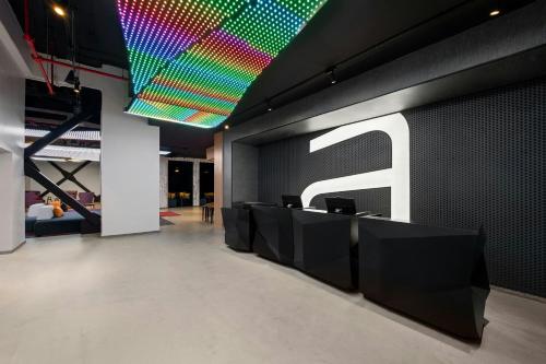 a lobby with colorful lights on the ceiling at Aloft Santo Domingo Piantini in Santo Domingo
