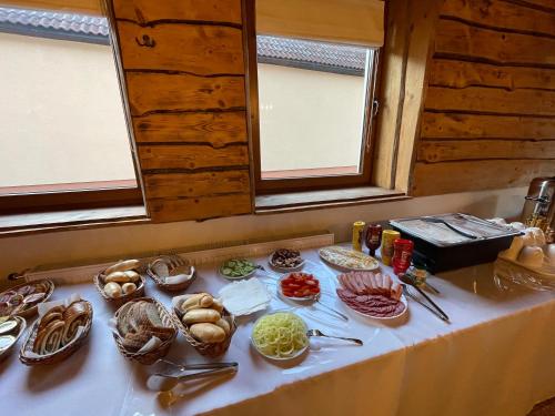 a table with many different types of food on it at Penzion Bistár in Habovka