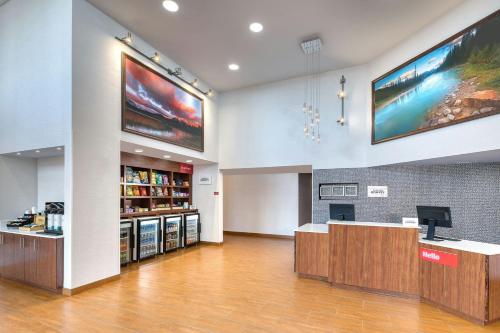 an empty lobby with a cash register and a pharmacy at TownePlace Suites by Marriott Red Deer in Red Deer