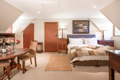 a bedroom with a bed and a table and chairs at Avemore Island Home- full power back up-magical views in Sedgefield