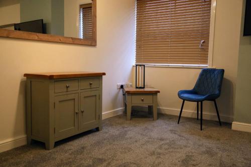 a room with a desk and a chair and a lamp at White Swan Cottage 2 in Hunmanby