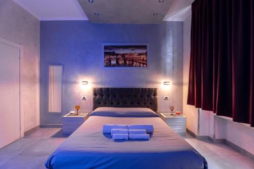 a bedroom with a large bed with two pillows on it at Giulia's house Roma in Rome