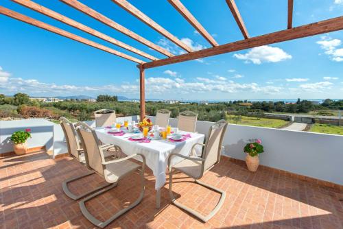 a table and chairs on a patio with a view at Orianna Sea View Villa in Gennadi