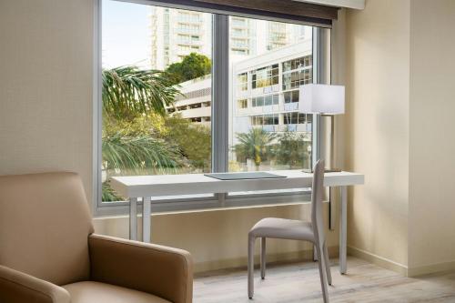 a desk and chair in a room with a large window at AC Hotel St Petersburg Downtown in St Petersburg