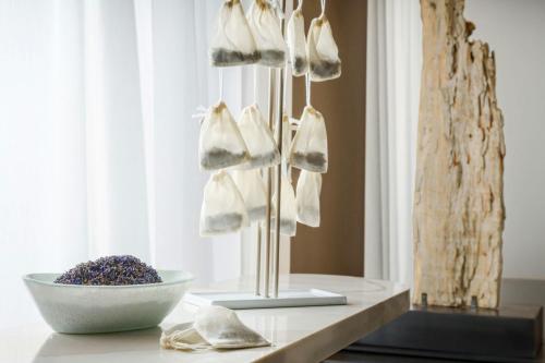 a group of white shoes on a stand next to a bowl at AC Hotel St Petersburg Downtown in St Petersburg