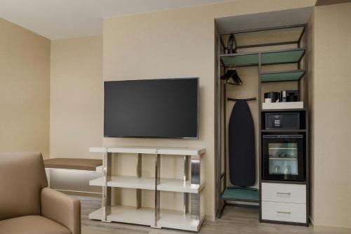 a living room with a flat screen tv on a wall at AC Hotel St Petersburg Downtown in St Petersburg