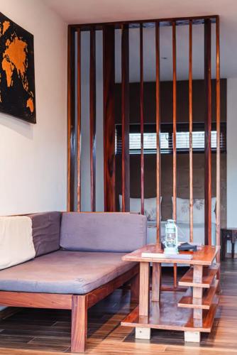 a living room with a couch and a table at Secret Garden Villa in Kendwa