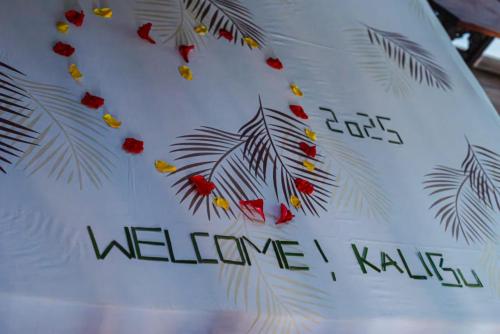a white shirt with leaves and the word welcome on it at Secret Garden Villa in Kendwa