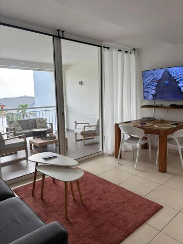 a living room with a couch and a table at Easy Friendly SXM in Cul de Sac