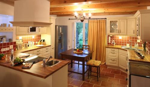a kitchen with a sink and a table in it at Romantic Cottage in Pitten