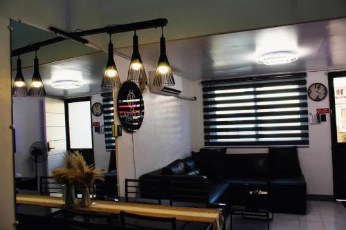 a living room with a couch and a table at Caryolba hometel - Calapan in Calapan