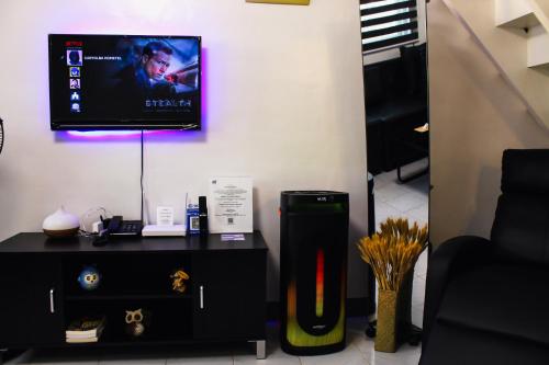 a living room with a tv and a black table at Caryolba hometel - Calapan in Calapan