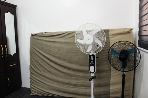 a white fan sitting on top of a bed at Caryolba hometel - Calapan in Calapan