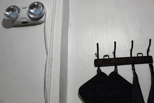 a room with hangers and a light on a wall at Caryolba hometel - Calapan in Calapan
