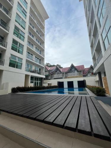 a wooden walkway in front of a building at Condo 604 Baguio retreat with pool and gym in Baguio