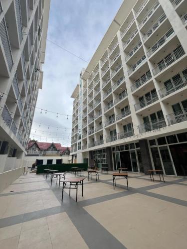 a large building with benches in front of it at Condo 604 Baguio retreat with pool and gym in Baguio