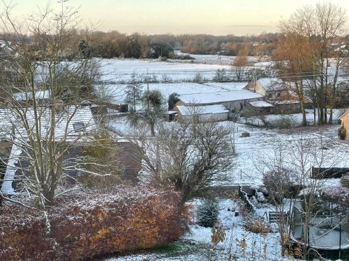 an aerial view of a snow covered field with houses at Chez Madeline in Hannut