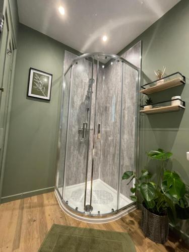 a shower with a glass enclosure in a bathroom at Rivendell Guest House in Keswick