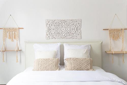 une chambre avec un lit blanc avec deux oreillers dans l'établissement Spacieux T2 proche la Défense, à Bezons