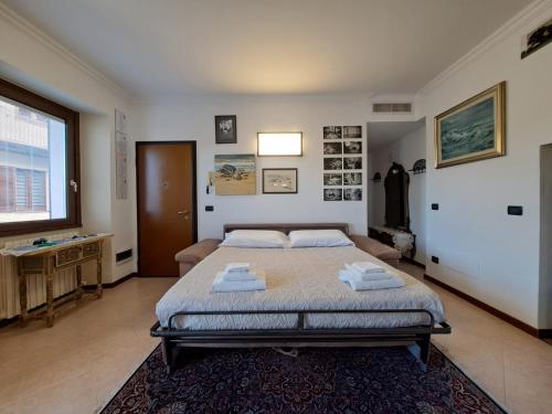 a bedroom with a large bed with towels on it at Le Rose Sul Lago in Pescate