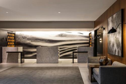 a lobby with a large painting on the wall at Le Meridien Houston Downtown in Houston