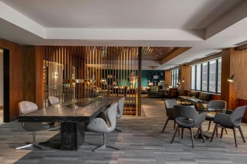 a lobby with a large table and chairs at Le Meridien Houston Downtown in Houston