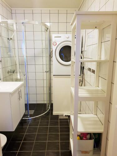 a laundry room with a washer and dryer in it at Mountain view 1 in Håra