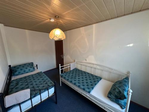 a room with two bunk beds and a chandelier at Kerpen Rarität in Kerpen
