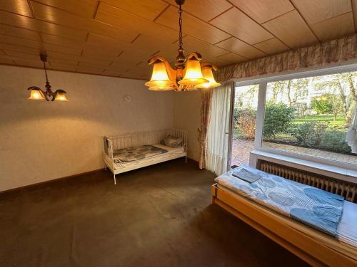 a room with two beds and a window and lights at Kerpen Rarität in Kerpen