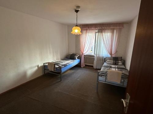 a small room with a bed and a window at Kerpen Rarität in Kerpen