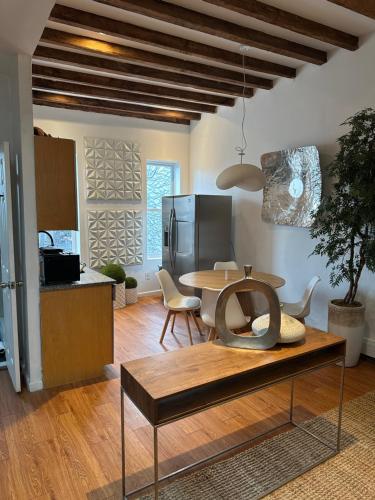 a living room with a table and a kitchen at A Dedicated Space To Unwind in Brooklyn