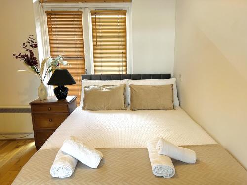 a bedroom with a bed with two slippers on it at Cosy Flat at Temple Bar Dublin in Dublin