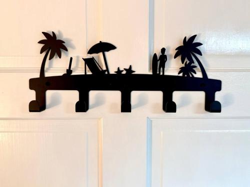 a wooden shelf with a laptop and cats on it at ZenBreak Steps to the Sea 3Bd in Saint Peter