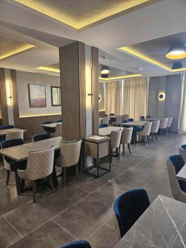 a dining room with tables and chairs in a restaurant at Kopaonik Lux Resident Hill Apartman A39 in Kopaonik