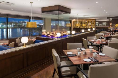 a restaurant with tables and chairs and a bar at South Sioux City Marriott Riverfront in South Sioux City