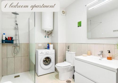 a bathroom with a washing machine and a sink at Luxury Apartaments in Costa Adeje, Los Geranois in Adeje
