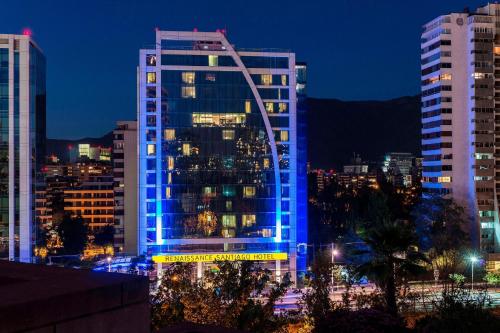 a tall building with blue lights on it at night at Renaissance Santiago by Marriott in Santiago