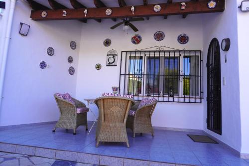 a patio with a table and chairs and plates on the wall at Cozy bungalow in Calpe in Calpe