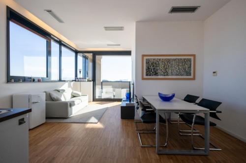 a kitchen and living room with a table and a couch at Bianca Apartments in Verona