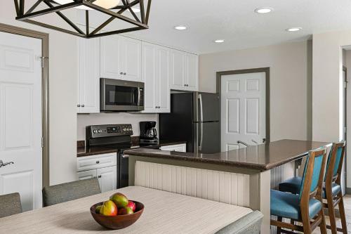 a kitchen with a bowl of fruit on a table at Sheraton Broadway Resort Villas in Myrtle Beach