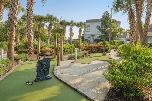 a golf course in a resort with palm trees at Sheraton Broadway Resort Villas in Myrtle Beach