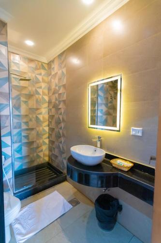 a bathroom with a sink and a glass shower at Museum Plaza in Cairo