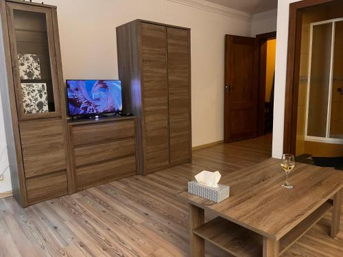 a living room with a table and a tv at Studio w centrum miasta in Dzierżoniów