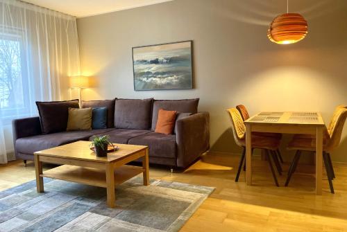 a living room with a couch and a table at Kuressaare Holiday Apartments in Kuressaare