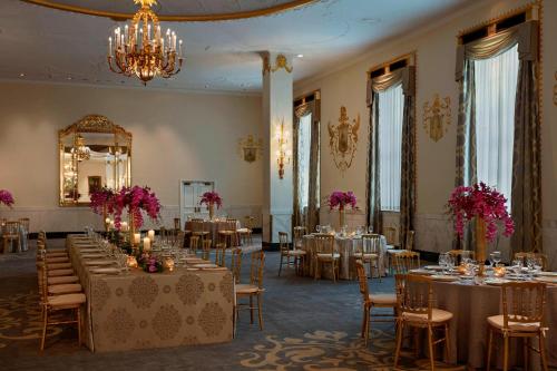 a banquet hall with tables and chairs and a mirror at The Mayflower Hotel, Autograph Collection in Washington